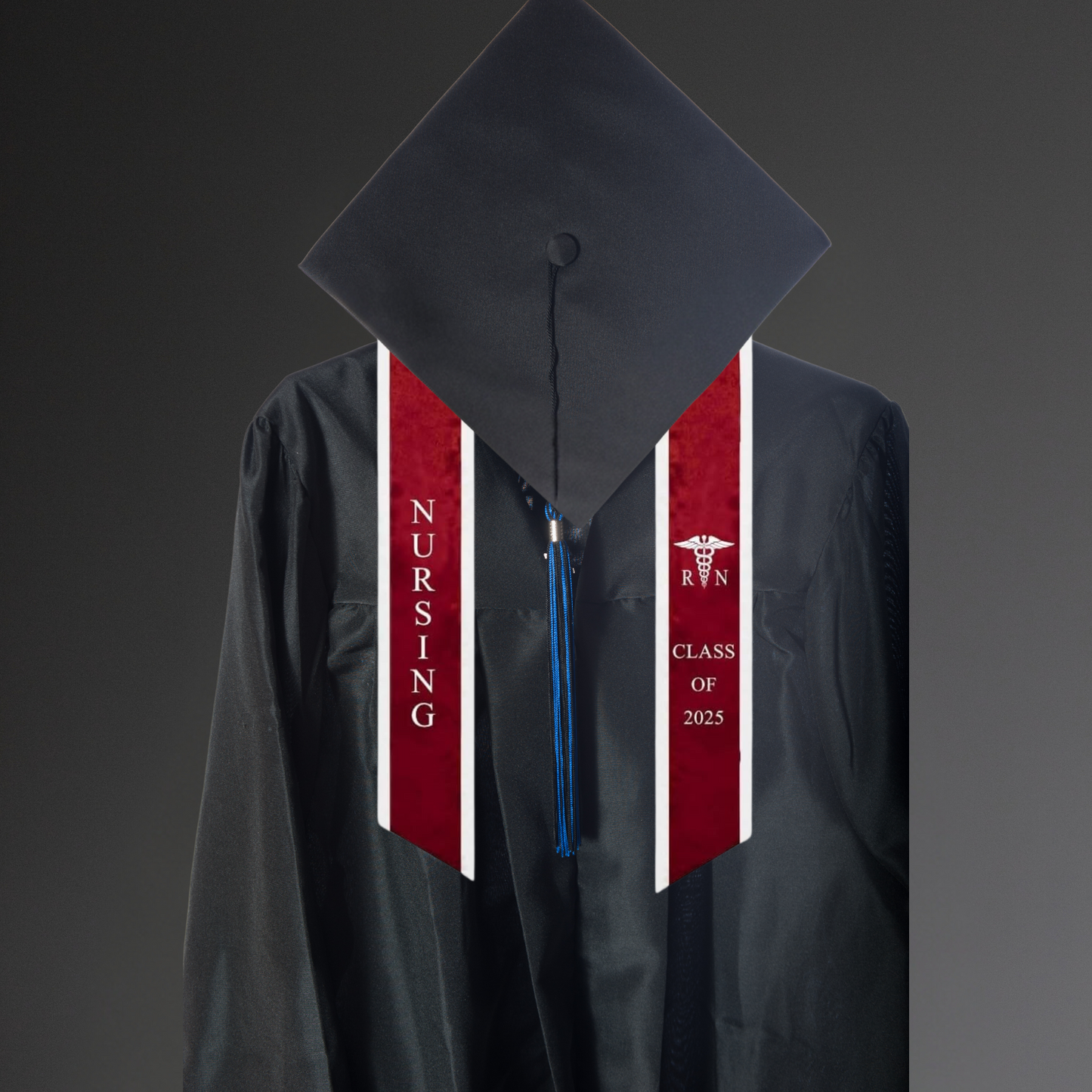 A burgundy nursing graduation stole with white trim, displaying bold vertical 'NURSING' lettering on the left, a medical logo with 'RN' at the top right, and 'CLASS OF 2025' embroidered horizontally below. The stole features slanted tips and a white plain background. All characters are embroidered. The stole is worn on top of black a graduation toga and graduation hat,