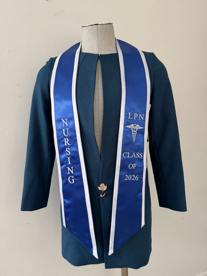 A Royal Blue With White Trim LPN graduation stole with royal blue trim, showcasing bold 'LPN ' lettering embroidered at the top, followed by a medical logo and 'CLASS OF 2026' embroidered beneath. The stole has slanted tips and a white plain background. All characters are embroidered.